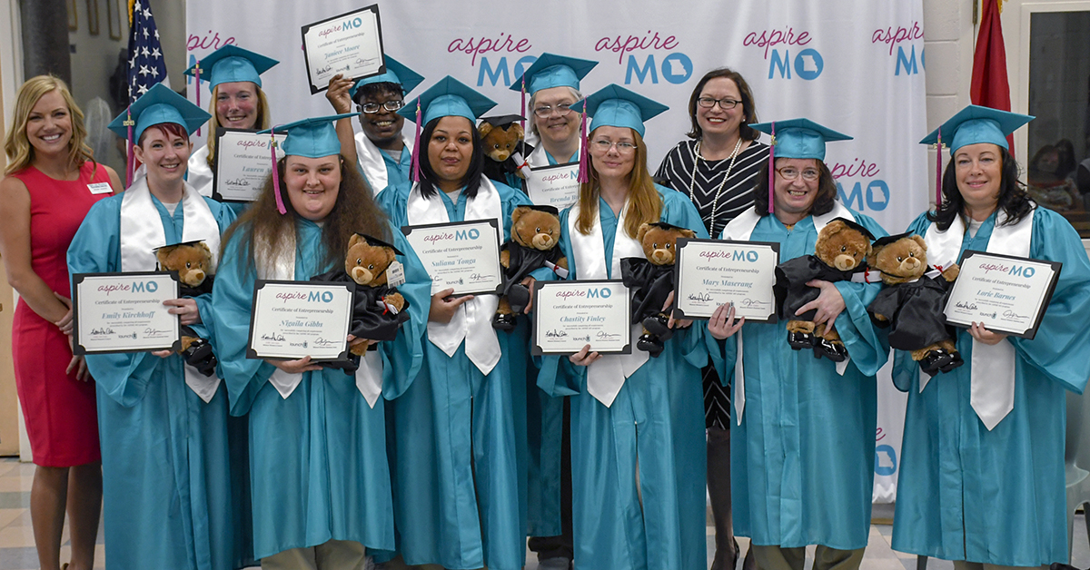 The ASPIRE MO class of 2019 smiles for cameras with their diplomas. Build-A-Bear donated a bear to every member within the program at the end of the ceremony.