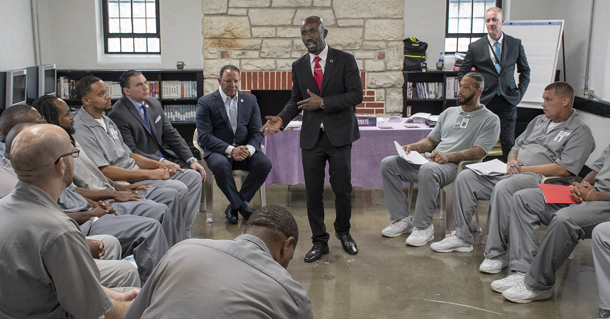 Facilitators lead a group of offenders in a reentry course.