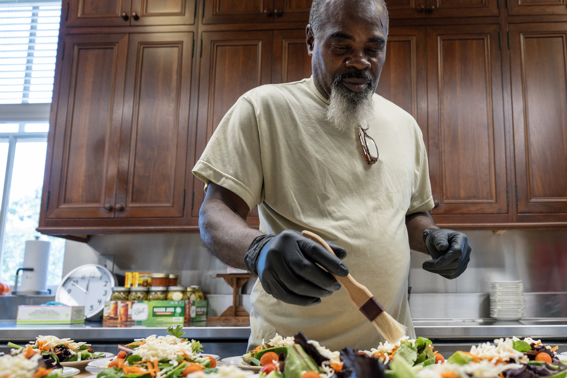 Sous Chef Thomas Buckner, a work-release program particpant, dresses salads.