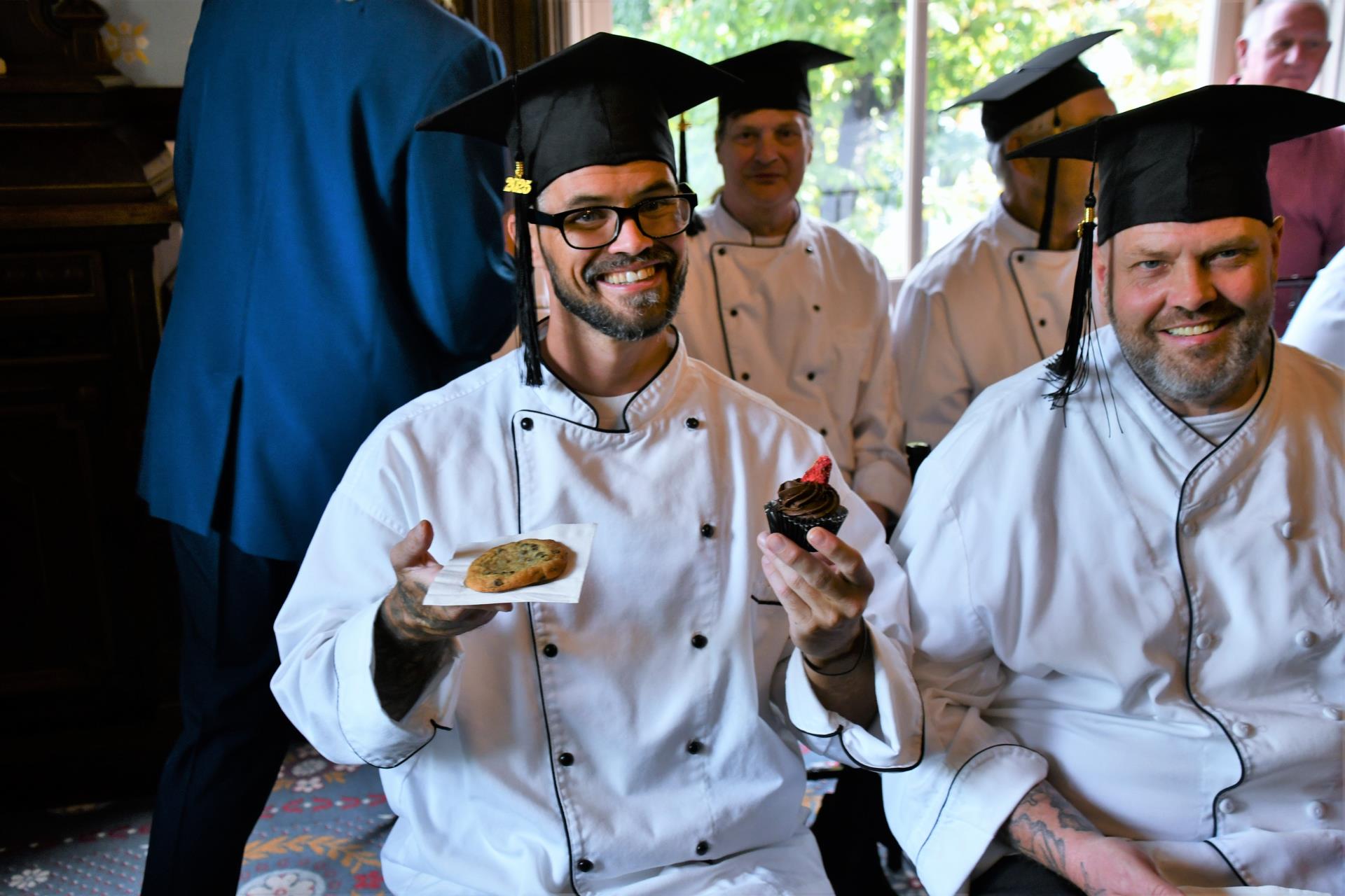 Graduates and guests at the event enjoy fresh-baked cookies and cupcakes.