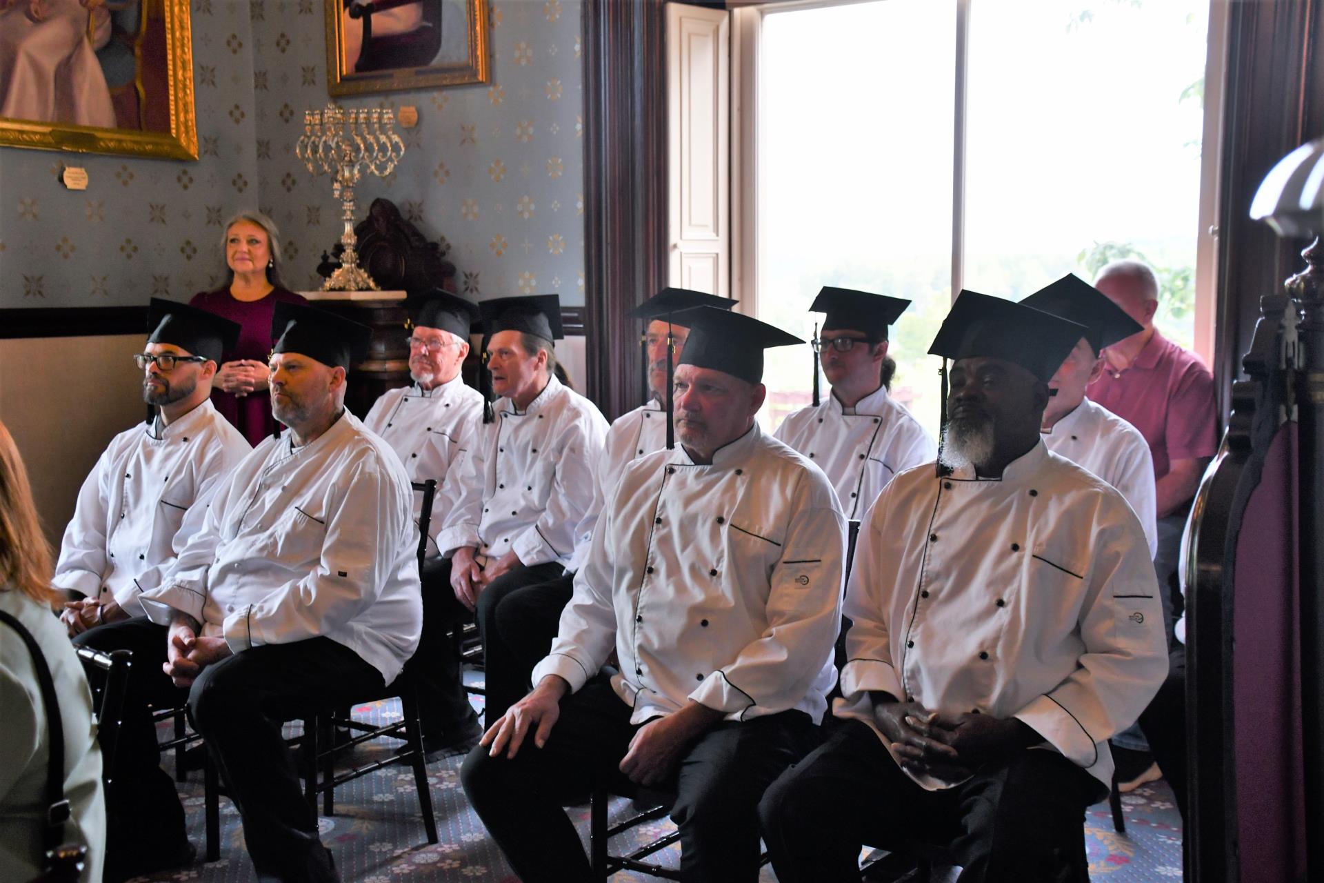 Work-release participants wait to receive their ServSafe certificates.