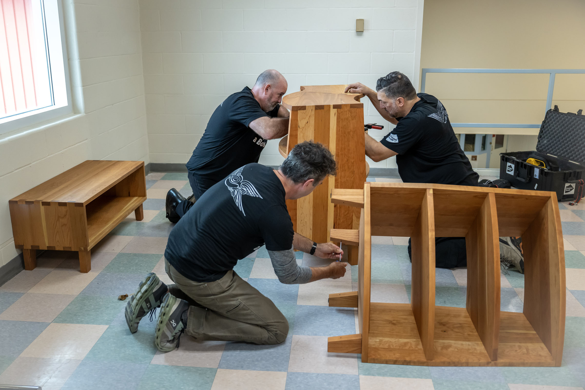 Freedom Reads workers assemble the bookcase.