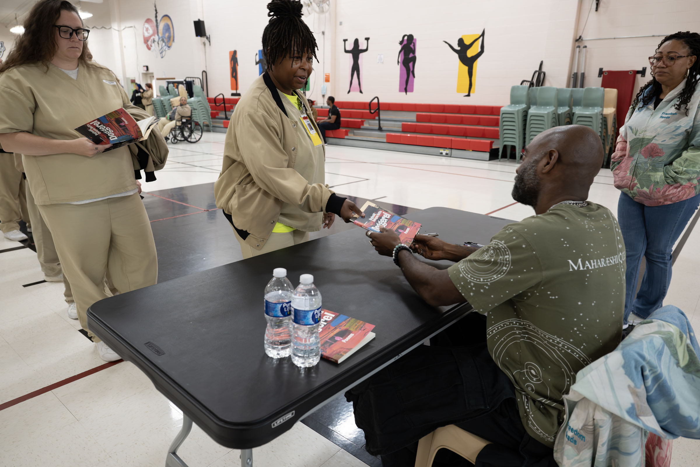 A resident of the women's prison in Vandalia receives a book signed by poet author Reginald Dwayne Betts.