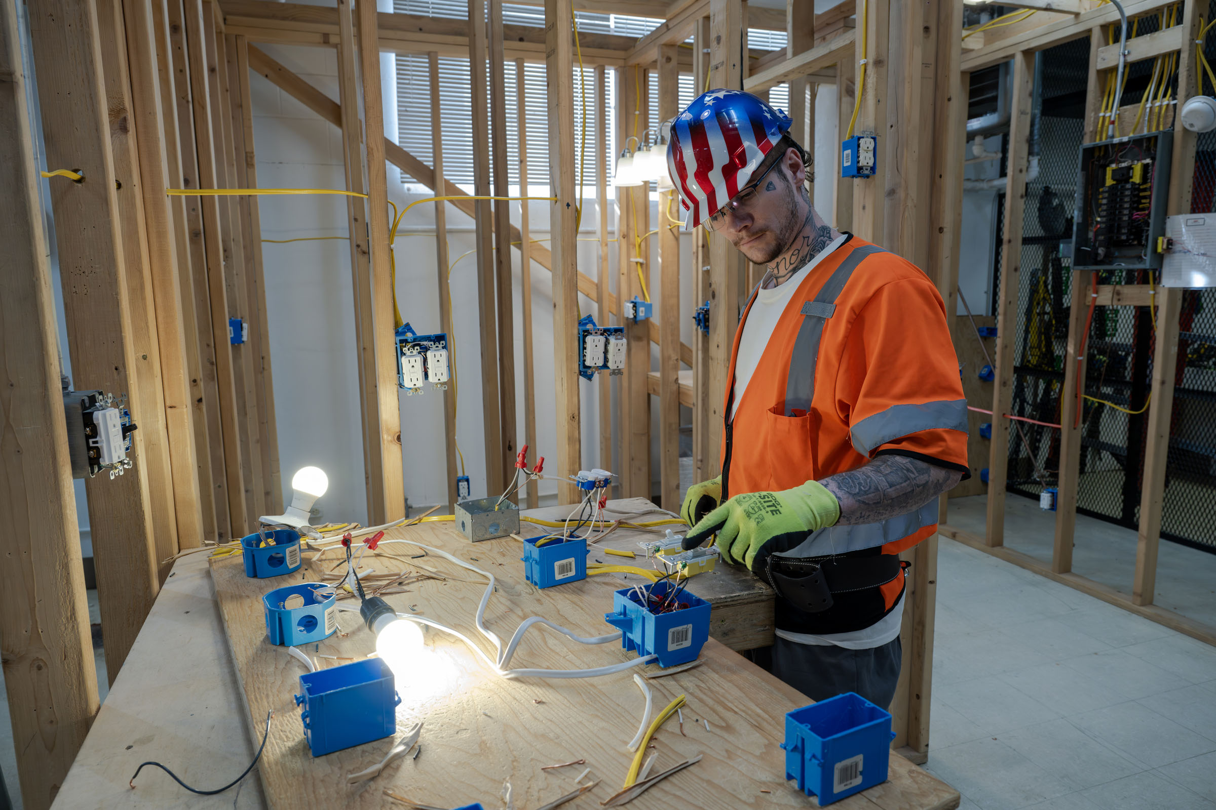 Student installs electrical hardware in mock apartment