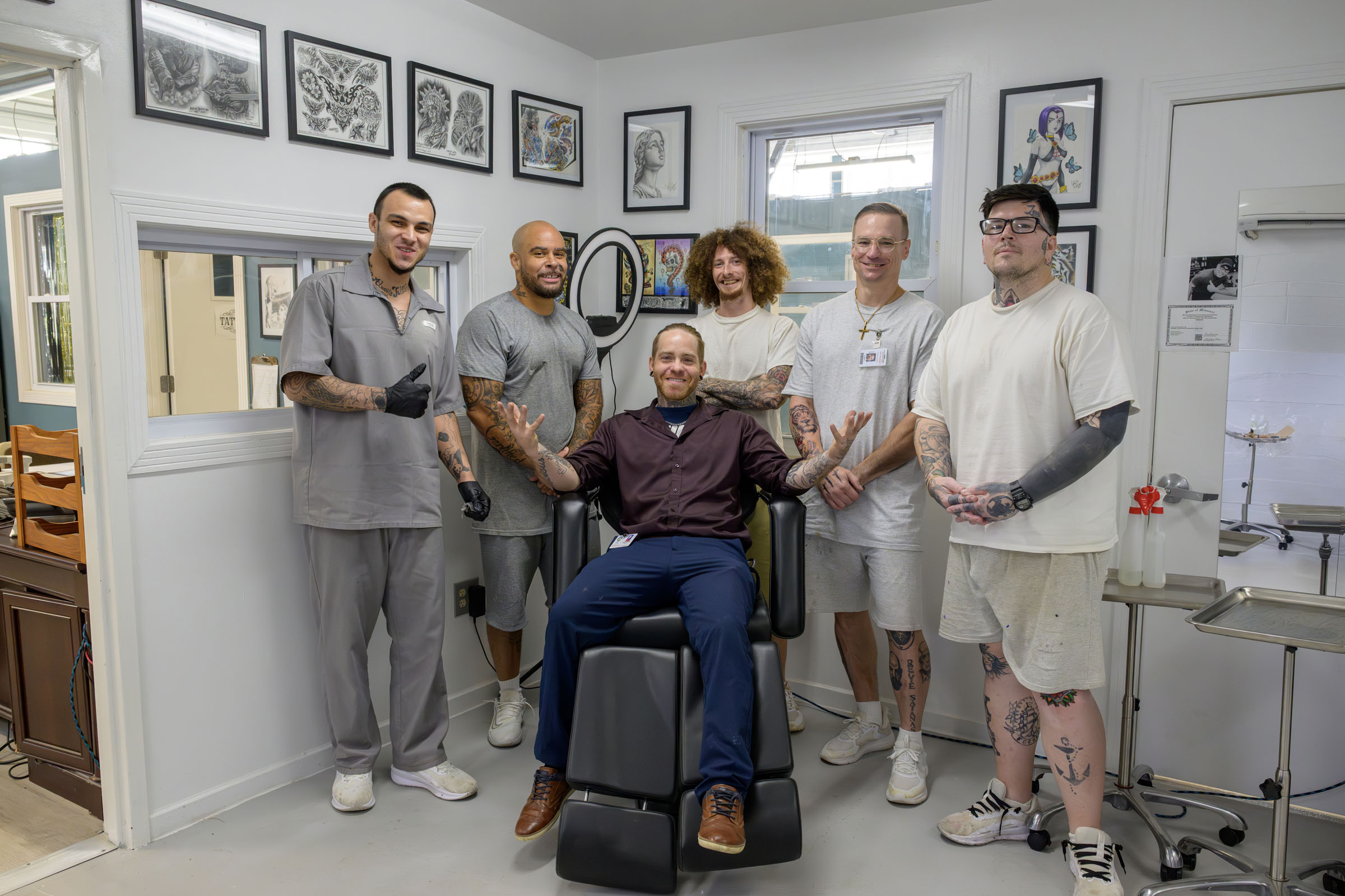 Instructor sits in chair surrounded by students.