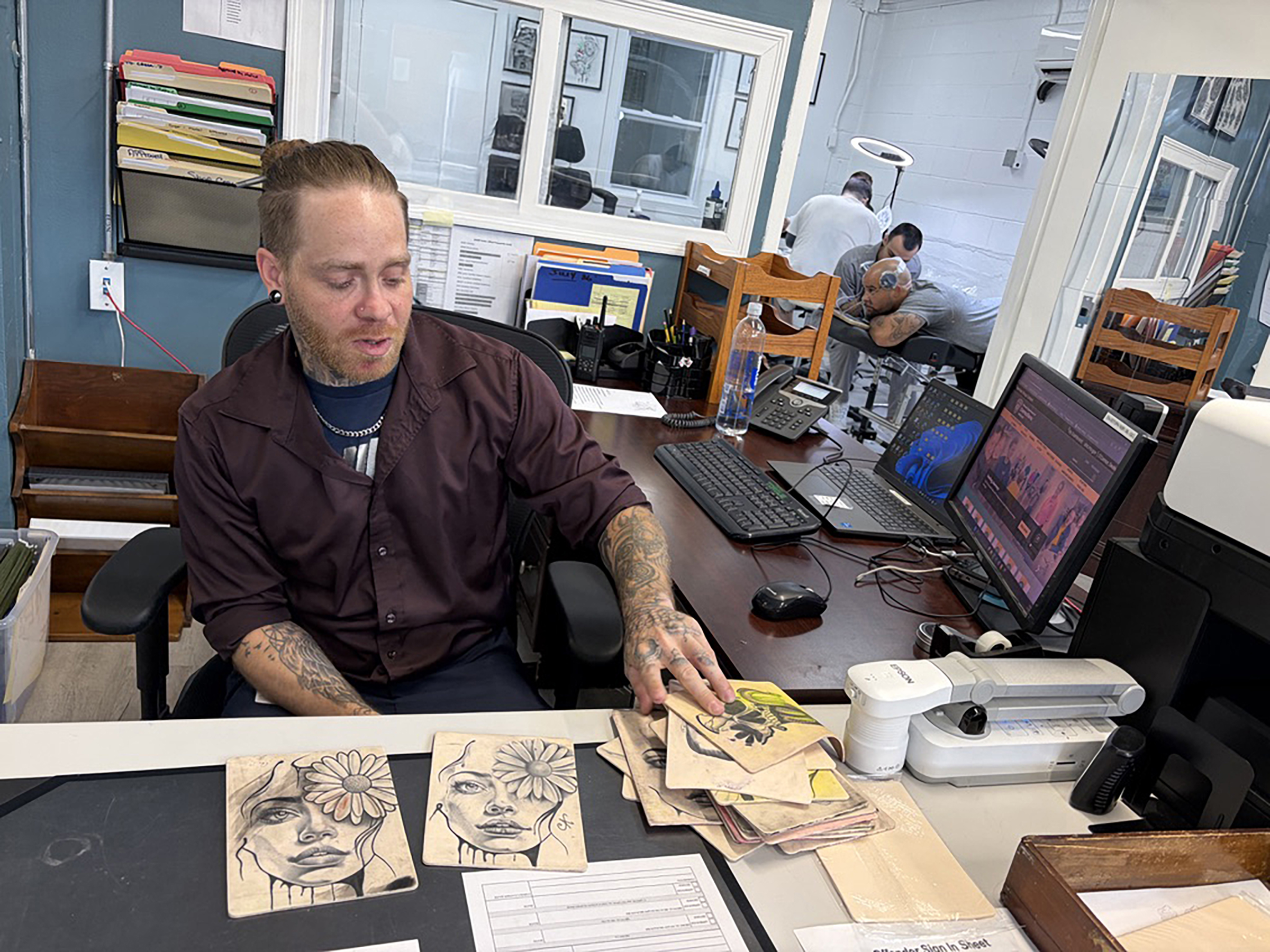 Instructor lays squares of rubber skins across his desk.
