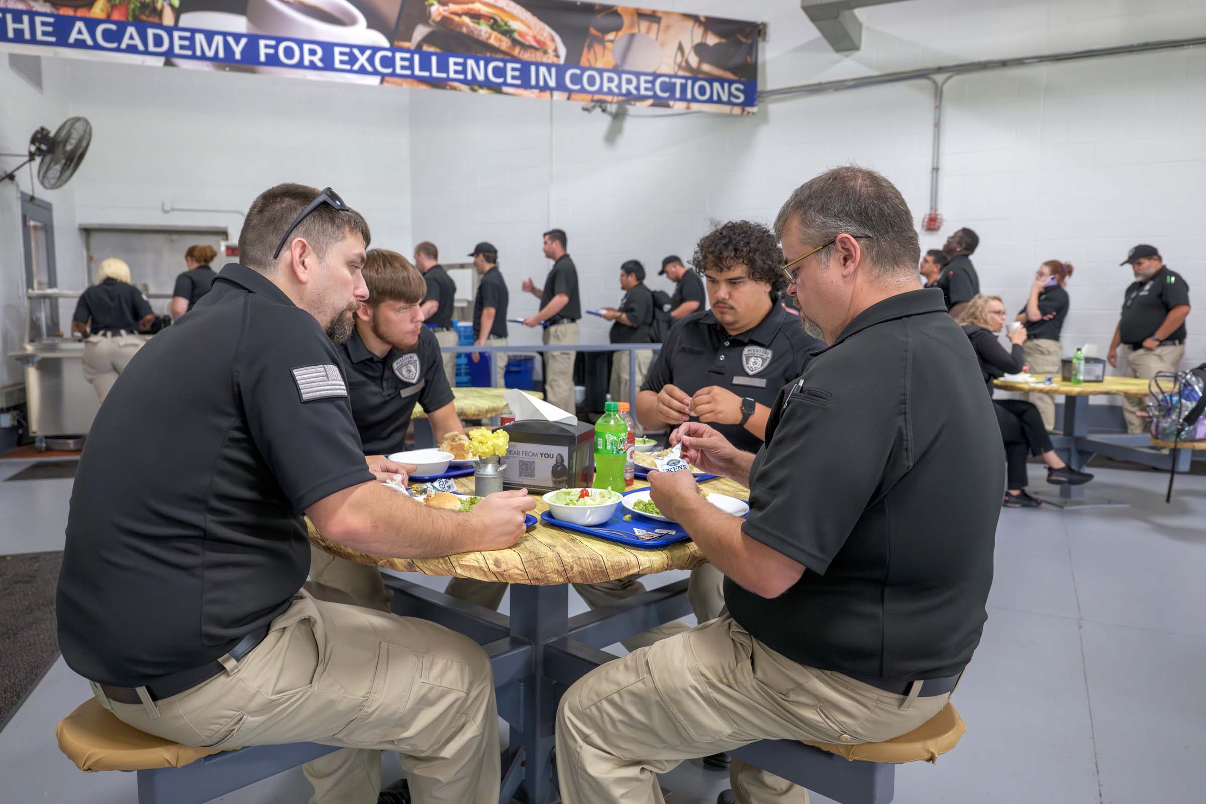 Four cadets eat lunch in the AEC cafeteria.