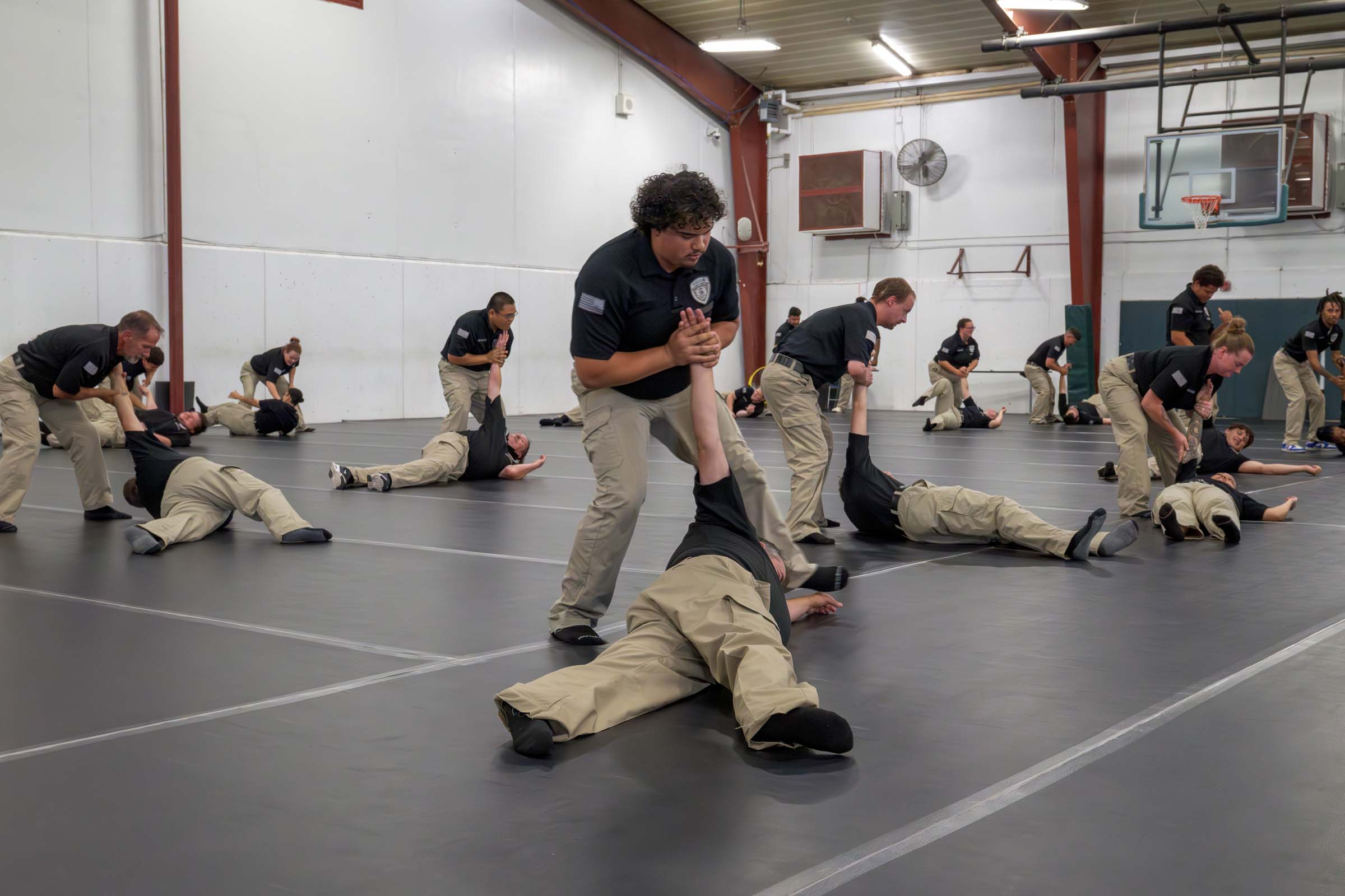 Students in the AEC gymnasium practice a variety of use-of-force techniques.