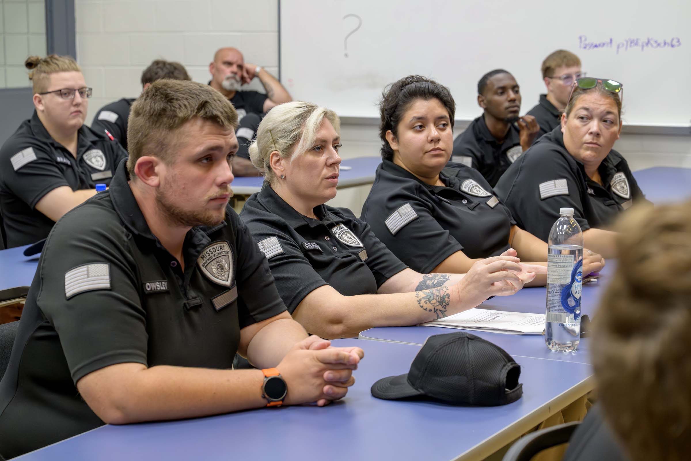 A row of corrections officers attends a lecture.