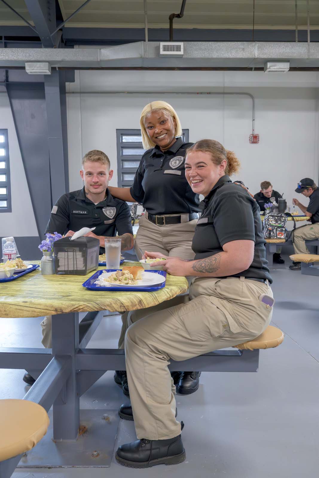 Three students pose for a photo in the AEC.