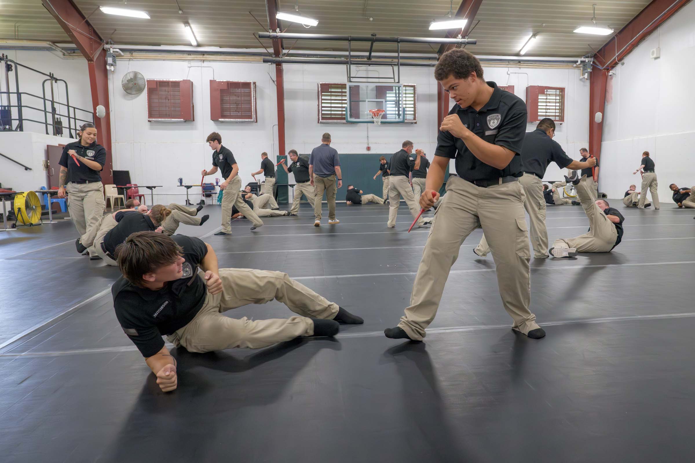 Students in the AEC gymnasium practice a variety of use-of-force techniques.