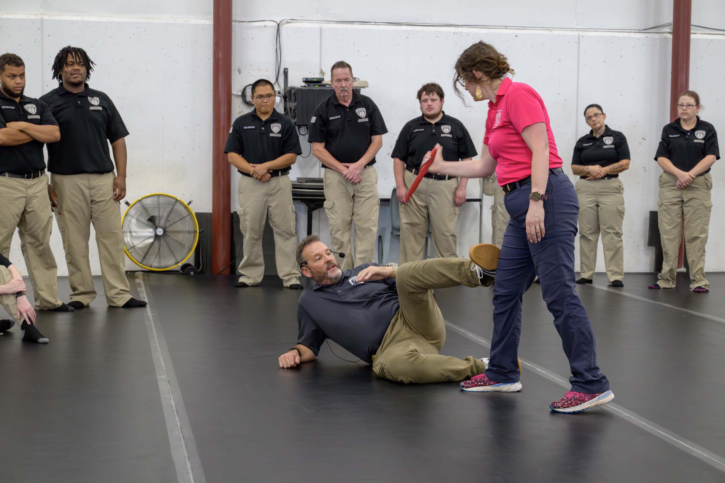 Brian Scheetz demonstrates kicking an assailant in the knee from a downed position on the mat.