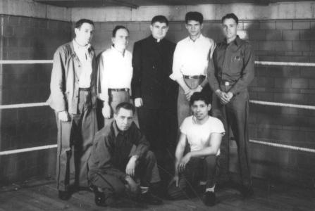 Chaplain with six prisoners from the mid-20th century.