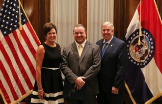 DW Brewer with Governor Parson and Director Precythe 