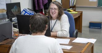 An addiction counselor meets with an offender