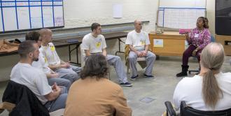 Addiction counselor Sharon Johnson meeting with offenders in a substance use disorder group.