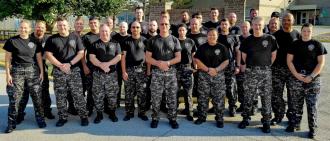 A Corrections Emergency Response Team in uniform, standing at attention