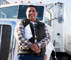 Man standing in front of a large truck