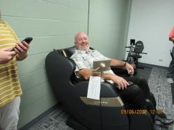Warden Warren trying out the massage chair