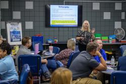 Christie Lewis lectures to a class full of students.