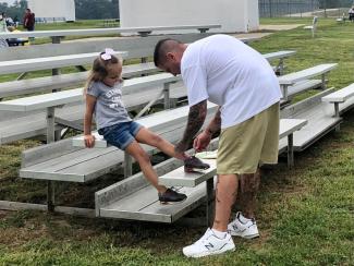resident tying a child's shoe