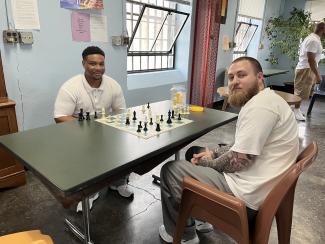 Two residents play chess in the Housing Unit Six honor dorm day room