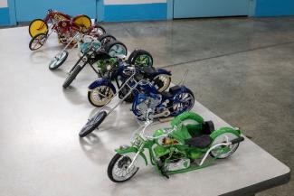 Row of colorfully painted miniaturized motorcycles