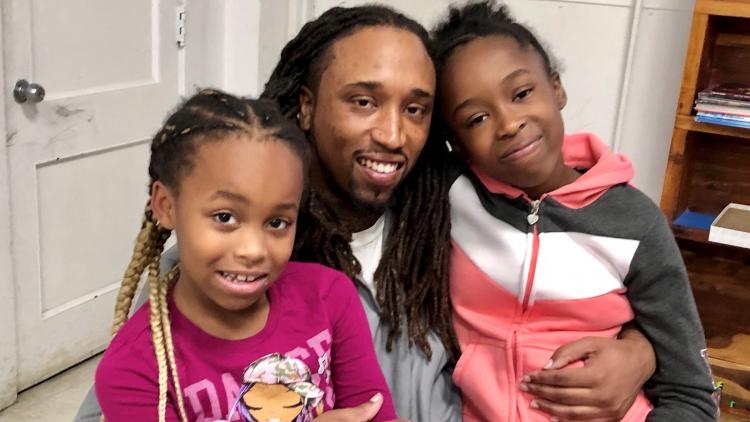 An incarcerated dad with his two daughters