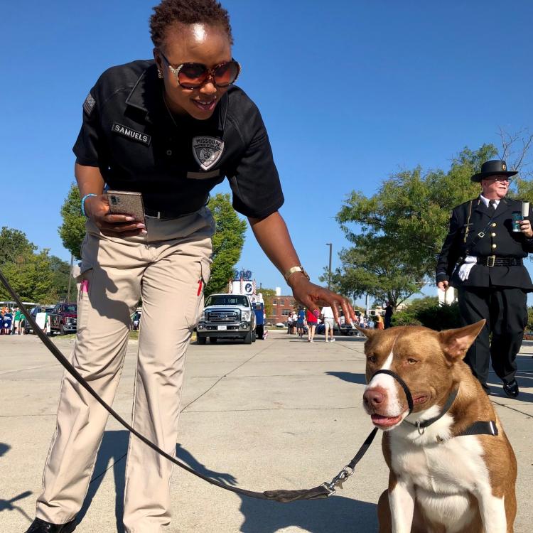 Officer Hannah Samuels with Puppies for Parole dog Stormy