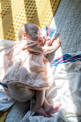 Baby sleeping in a sunbeam