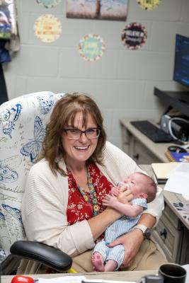Prison Nursery Program Manager Kimberley Perkins holds a baby.