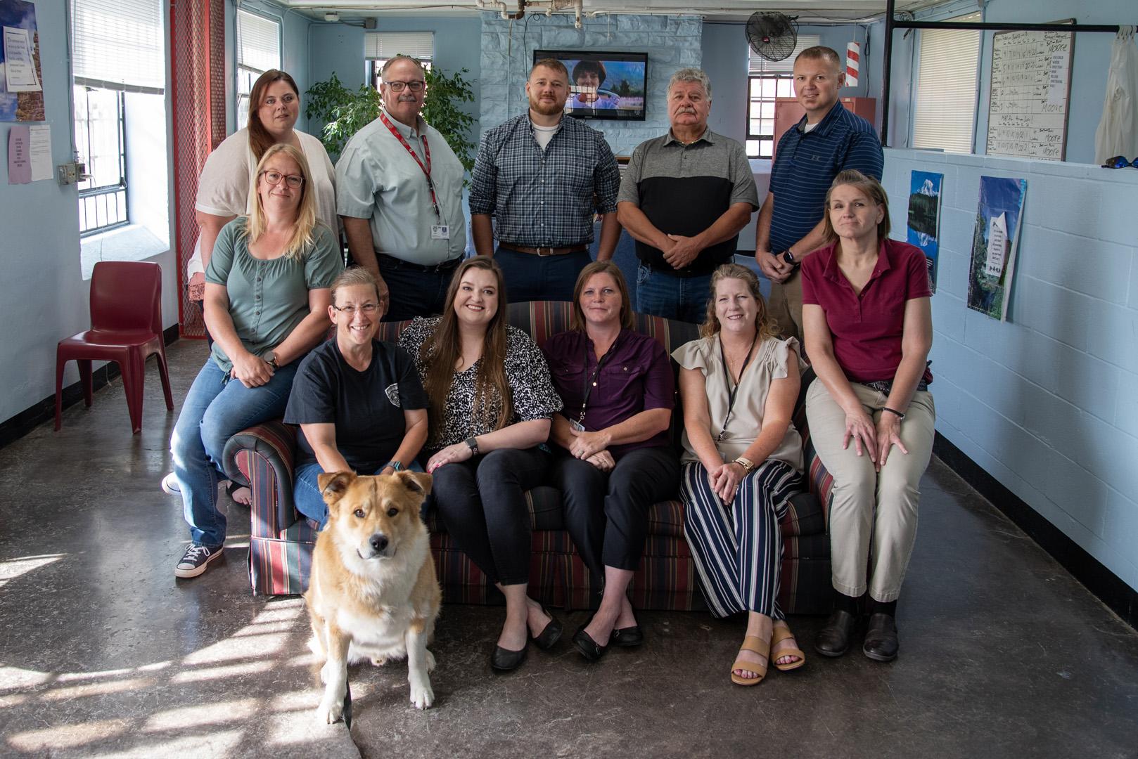 A team of 11 staff members and house dog Honor in the Algoa Correctional Center Honor Dorm.