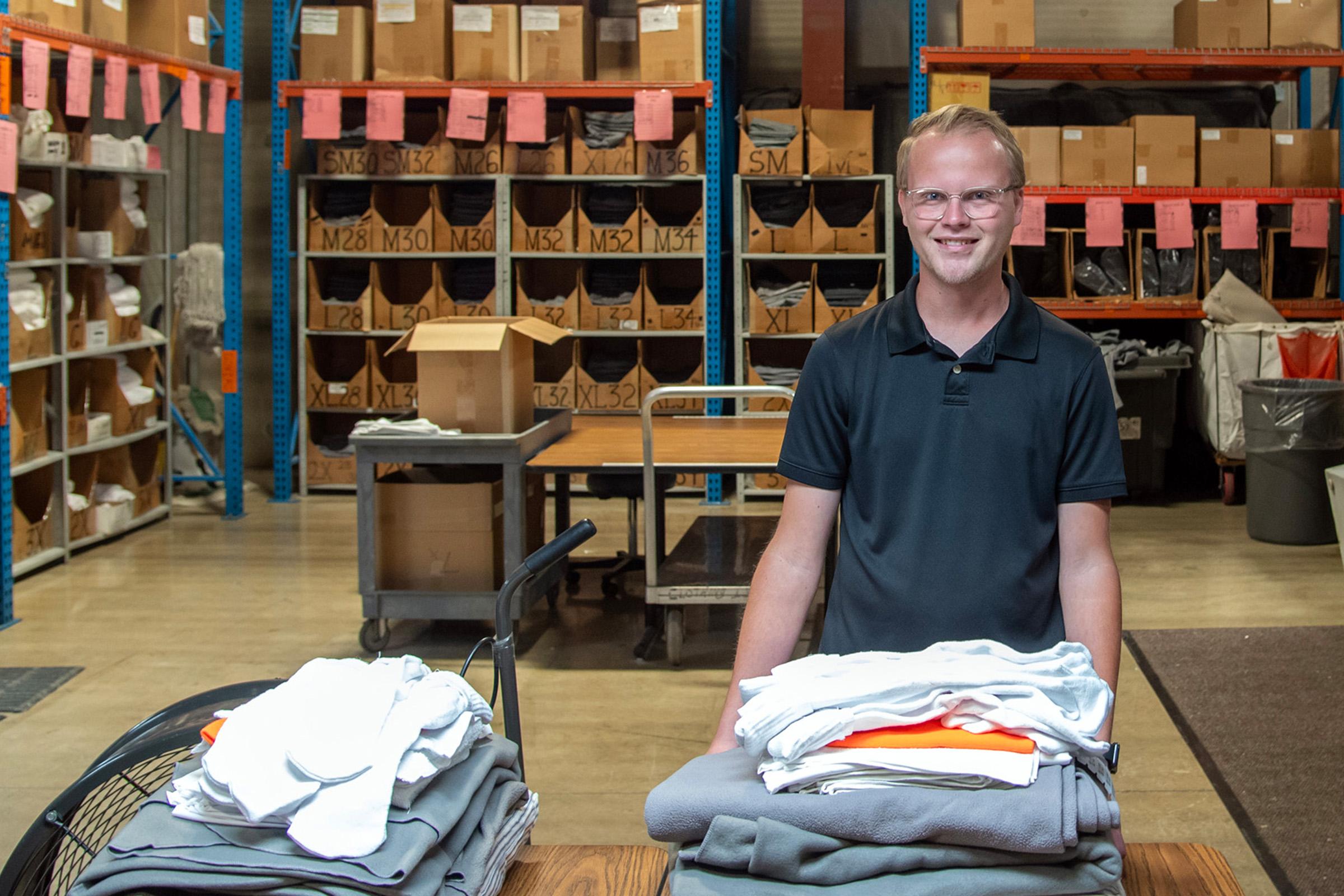 A young man poses in the clothing issue section at a prison